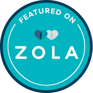 Circular teal badge with two overlapping hearts above text that reads “Featured on Zola” for this Tilghman Island wedding venue.
